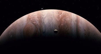 Movie still from “The Tree of Life” (2011), directed by Terrence Malick – An illustration of jupiter and its moons in space; Extreme Wide shot, Overhead angle