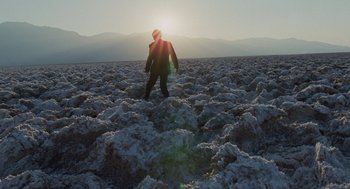 Movie still from “The Tree of Life” (2011), directed by Terrence Malick – A person standing in the middle of an open field; Extreme Wide shot, Low angle