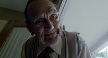 Movie still from “The Tree of Life” (2011), directed by Terrence Malick – An old man wearing a neck tie and smiling; Close Up shot, Low angle