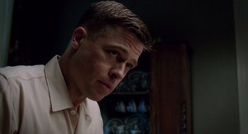 Movie still from “The Tree of Life” (2011), directed by Terrence Malick – A person wearing a white shirt; Close Up shot, Low angle