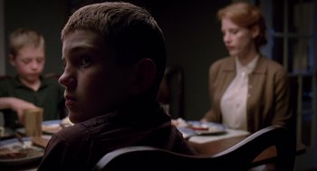 Movie still from “The Tree of Life” (2011), directed by Terrence Malick – A boy and a woman sitting at a table; Close Up shot, Over the shoulder angle