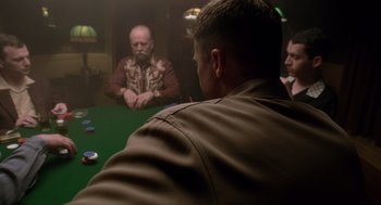 Movie still from “The Tree of Life” (2011), directed by Terrence Malick – A group of men sitting around a table playing a game; Medium shot, Over the shoulder angle