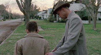 Movie still from “The Tree of Life” (2011), directed by Terrence Malick – A man and a young boy standing in the grass; Medium shot, Over the shoulder angle