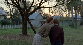 Movie still from “The Tree of Life” (2011), directed by Terrence Malick – A woman and a boy in a yard; Wide shot, Over the shoulder angle