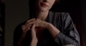 Movie still from “The Tree of Life” (2011), directed by Terrence Malick – A woman putting a ring on her finger; Close Up shot, Over the shoulder angle