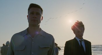 Movie still from “The Tree of Life” (2011), directed by Terrence Malick – A man standing next to another man on a beach; Close Up shot, Low angle