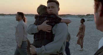 Movie still from “The Tree of Life” (2011), directed by Terrence Malick – A man holding a young boy in his arms; Medium shot, Over the shoulder angle