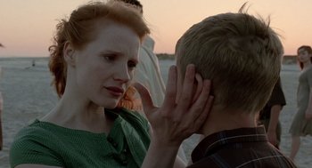 Movie still from “The Tree of Life” (2011), directed by Terrence Malick – A young man and a young woman talking to each other; Close Up shot, Over the shoulder angle