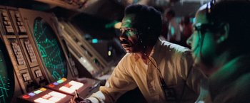Movie still from “Close Encounters of the Third Kind” (1977), directed by Steven Spielberg – A man with a face paint sitting at a table; Close Up shot, Low angle