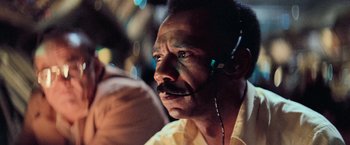 Movie still from “Close Encounters of the Third Kind” (1977), directed by Steven Spielberg – A man wearing a headset looking into the distance; Close Up shot, Low angle
