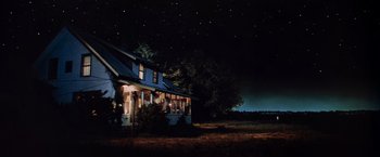 Movie still from “Close Encounters of the Third Kind” (1977), directed by Steven Spielberg – A night time scene of a farm house with stars in the background; Extreme Wide shot, Low angle