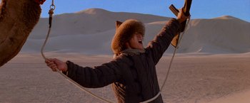 Movie still from “Close Encounters of the Third Kind” (1977), directed by Steven Spielberg – A person in a fur hat and coat holding a rope; Medium shot, Low angle