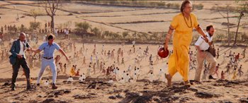 Movie still from “Close Encounters of the Third Kind” (1977), directed by Steven Spielberg – A crowd of people walking across a field; Extreme Wide shot, High angle