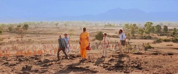 Movie still from “Close Encounters of the Third Kind” (1977), directed by Steven Spielberg – A group of people standing on top of a dirt hill; Wide shot, Low angle