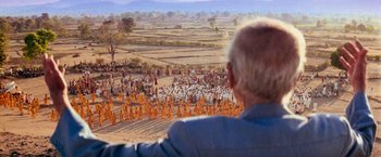 Movie still from “Close Encounters of the Third Kind” (1977), directed by Steven Spielberg – An old man looking at a large group of people; Extreme Wide shot, Over the shoulder angle
