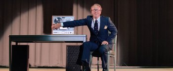 Movie still from “Close Encounters of the Third Kind” (1977), directed by Steven Spielberg – An older man sitting in front of an old television; Medium shot, Low angle