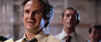 Movie still from “Close Encounters of the Third Kind” (1977), directed by Steven Spielberg – Two men in business suits and ties looking at the camera; Close Up shot, Low angle