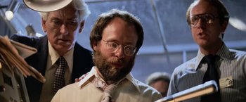 Movie still from “Close Encounters of the Third Kind” (1977), directed by Steven Spielberg – A man with a beard wearing glasses and a tie; Close Up shot, Low angle