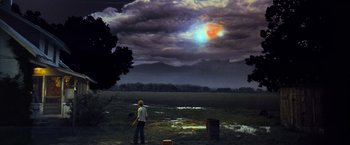 Movie still from “Close Encounters of the Third Kind” (1977), directed by Steven Spielberg – A man standing in a field under a cloudy sky; Extreme Wide shot, Low angle