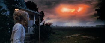 Movie still from “Close Encounters of the Third Kind” (1977), directed by Steven Spielberg – A storm is coming up from the ground; Extreme Wide shot, Over the shoulder angle