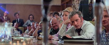 Movie still from “Close Encounters of the Third Kind” (1977), directed by Steven Spielberg – A group of people sitting around a table; Medium shot, High angle