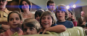 Movie still from “Close Encounters of the Third Kind” (1977), directed by Steven Spielberg – A group of people sitting in a row on a couch; Close Up shot, Low angle