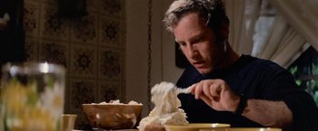 Movie still from “Close Encounters of the Third Kind” (1977), directed by Steven Spielberg – A man is eating a bowl of mashed potatoes; Close Up shot, Low angle