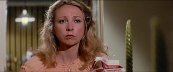 Movie still from “Close Encounters of the Third Kind” (1977), directed by Steven Spielberg – A young woman with long blonde hair holding a box of cereal; Close Up shot, Low angle