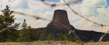 Movie still from “Close Encounters of the Third Kind” (1977), directed by Steven Spielberg – A view of a large rock formation from a distance; Extreme Wide shot, Low angle
