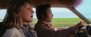 Movie still from “Close Encounters of the Third Kind” (1977), directed by Steven Spielberg – A man and a woman in a car looking out the window; Close Up shot, Low angle