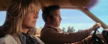 Movie still from “Close Encounters of the Third Kind” (1977), directed by Steven Spielberg – A man and a woman in the driver's seat of a car; Close Up shot, Low angle