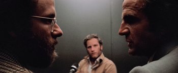 Movie still from “Close Encounters of the Third Kind” (1977), directed by Steven Spielberg – Two men are looking at each other in a mirror; Close Up shot, Over the shoulder angle