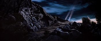 Movie still from “Close Encounters of the Third Kind” (1977), directed by Steven Spielberg – A person is standing on top of a mountain at night; Extreme Wide shot, Low angle