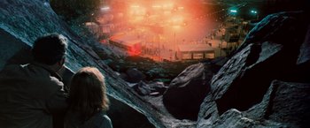Movie still from “Close Encounters of the Third Kind” (1977), directed by Steven Spielberg – A woman standing on top of a mountain looking at a crowd; Extreme Wide shot, High angle