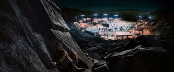 Movie still from “Close Encounters of the Third Kind” (1977), directed by Steven Spielberg – A man climbing up a rock wall at night; Extreme Wide shot, High angle