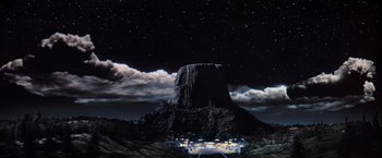 Movie still from “Close Encounters of the Third Kind” (1977), directed by Steven Spielberg – An image of a night sky with a mountain in the background; Extreme Wide shot, Low angle
