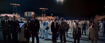 Movie still from “Close Encounters of the Third Kind” (1977), directed by Steven Spielberg – A group of men standing in front of each other; Extreme Wide shot, High angle