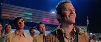 Movie still from “Close Encounters of the Third Kind” (1977), directed by Steven Spielberg – A group of men standing next to each other in front of a building at night; Close Up shot, Low angle