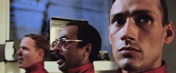 Movie still from “Close Encounters of the Third Kind” (1977), directed by Steven Spielberg – Two men are standing in front of a computer screen; Close Up shot, Low angle