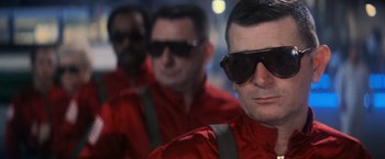 Movie still from “Close Encounters of the Third Kind” (1977), directed by Steven Spielberg – A group of men wearing sunglasses and red jackets; Close Up shot, Low angle