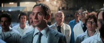 Movie still from “Close Encounters of the Third Kind” (1977), directed by Steven Spielberg – A group of men standing next to each other in a room; Close Up shot, Low angle