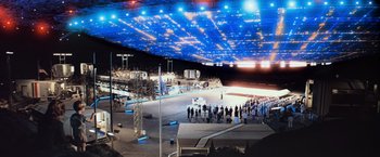 Movie still from “Close Encounters of the Third Kind” (1977), directed by Steven Spielberg – A crowd of people standing under a blue sky; Extreme Wide shot, Low angle
