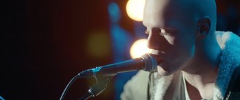 Movie still from “Clouds” (2020), directed by Justin Baldoni – A person holding a microphone; Close Up shot, Over the shoulder angle