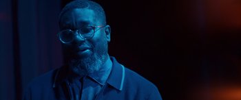 Movie still from “Clouds” (2020), directed by Justin Baldoni – A man with a beard wearing glasses and a blue jacket; Close Up shot, Low angle