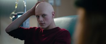 Movie still from “Clouds” (2020), directed by Justin Baldoni – A man with a bald head sitting on a couch; Close Up shot, High angle