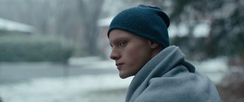 Movie still from “Clouds” (2020), directed by Justin Baldoni – A man wearing a blue hat and a gray jacket; Close Up shot, Low angle