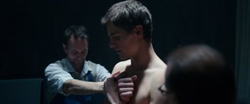 Movie still from “Clouds” (2020), directed by Justin Baldoni – A young man getting his chest waxed by a barber; Close Up shot, Over the shoulder angle