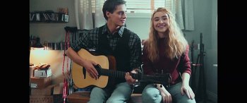Movie still from “Clouds” (2020), directed by Justin Baldoni – A man and a woman sitting next to each other holding a guitar; Medium shot, Over the shoulder angle