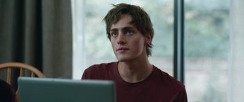 Movie still from “Clouds” (2020), directed by Justin Baldoni – A man sitting in front of a computer looking at the camera; Close Up shot, Over the shoulder angle