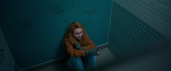 Movie still from “Clouds” (2020), directed by Justin Baldoni – A woman sitting on the ground in a bathroom; Medium shot, High angle